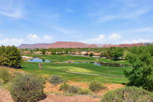 View of property's community with a water and mountain view, a residential view, and view of golf course