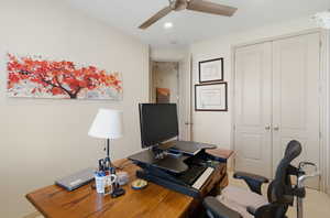 Office with ceiling fan and recessed lighting