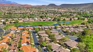 Aerial view of residential area with a water and mountain view and a local golf course