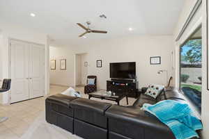 Living area featuring ceiling fan, light tile patterned flooring, recessed lighting, and vaulted ceiling