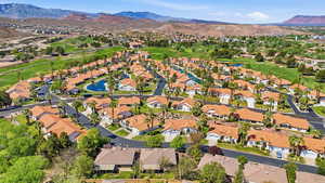 Aerial view of property and surrounding area featuring a water and mountain view and nearby suburban area