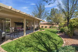 Fenced backyard with a patio and outdoor lounge area