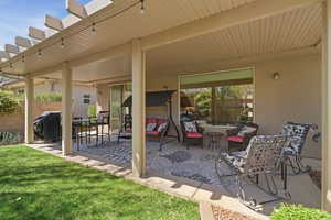 View of patio / terrace with grilling area, an outdoor living / dining area, and a pergola