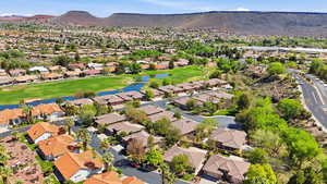 Aerial perspective of suburban area with a water and mountain view and a golf club