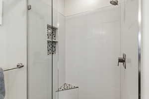 Full bathroom featuring a shower stall