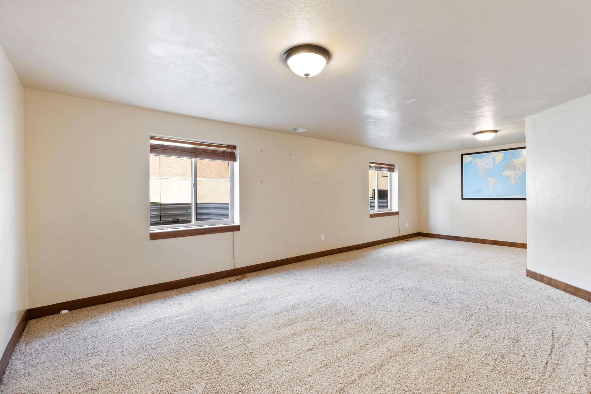 Spare room with plenty of natural light and light colored carpet