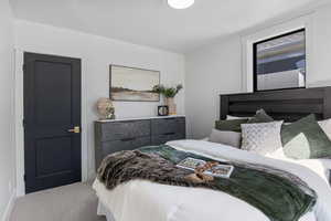 Bedroom with light colored carpet