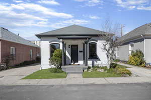 View of front of house with a shingled roof
