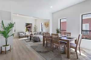 Dining area with light wood-type flooring, recessed lighting, and plenty of natural light