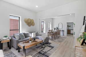 Living room featuring light wood-type flooring and recessed lighting