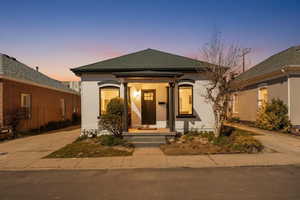 View of front of house featuring roof with shingles and a porch