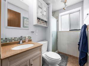 Bathroom with vanity and a shower stall