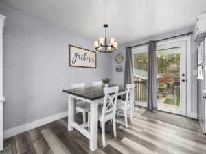 Dining space with light wood-style flooring, hanging lights, and a textured ceiling