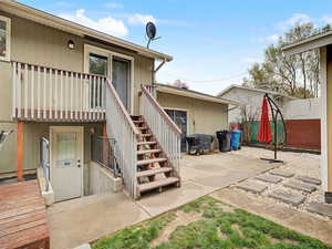 Rear view of house with stairs and a patio area