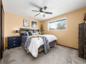 Bedroom with carpet floors and a ceiling fan