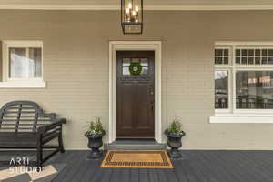 View of exterior entry with brick siding