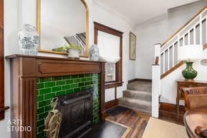 Entrance foyer with dark wood-style flooring and ornamental molding