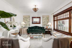 Living room featuring wood finished floors and ornamental molding