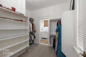 Walk in closet with light carpet