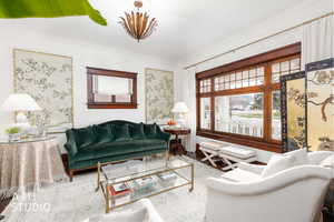 Living area featuring wood finished floors and ornamental molding