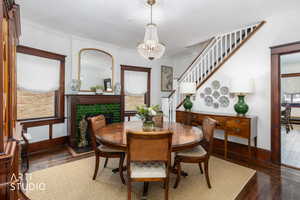 Dining area featuring plenty of natural light, a chandelier, hardwood / wood-style flooring, and ornamental molding