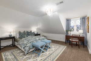 Bedroom featuring dark colored carpet and vaulted ceiling