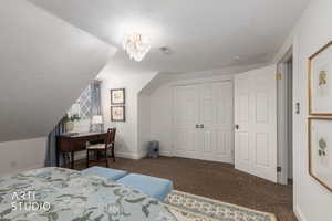 Bedroom featuring dark carpet and a closet