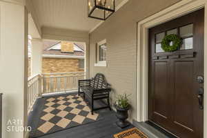 Doorway to property featuring brick siding