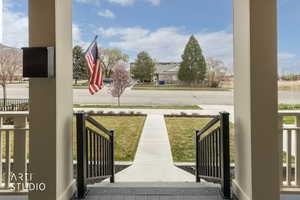 View of green lawn with a porch