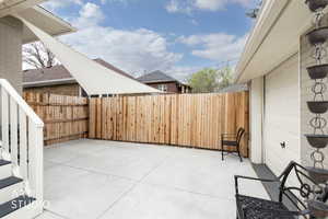 Fenced backyard with a patio