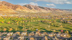 Aerial view of residential area with mountains and a golf club