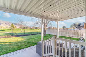 Fenced backyard featuring a patio area and a mountain view