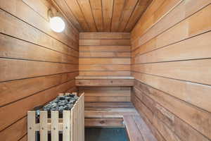 Relaxing sauna featuring wood walls and wood ceiling