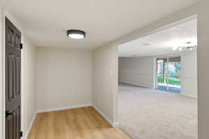 Hallway featuring baseboards and light wood-style flooring