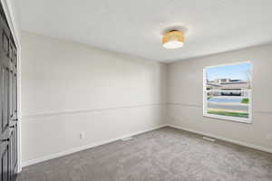 Unfurnished room with light colored carpet and baseboards