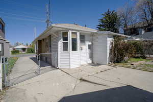 View of front of home featuring a gate and a patio