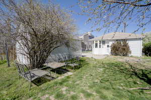 View of green lawn with a patio area