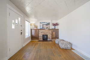 Living room featuring hardwood / wood-style floors and baseboards