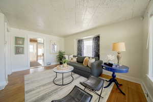 Living room with wood finished floors and baseboards