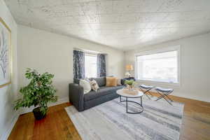 Living area featuring baseboards and light wood-style flooring