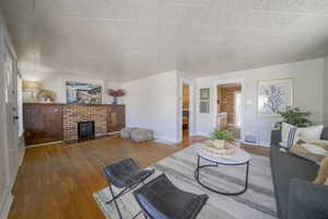 Living area with hardwood / wood-style floors and a fireplace