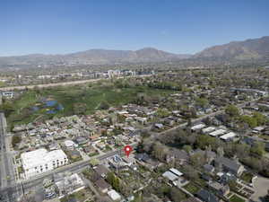 Aerial perspective of suburban area featuring a water and mountain view and a golf club