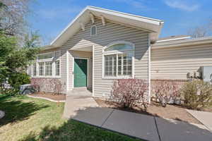 Doorway to property featuring a yard