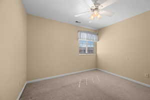 Carpeted empty room with baseboards and ceiling fan