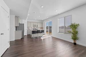 View of open concept kitchen and dining space featuring recessed lighting, LVP flooring, and natural light