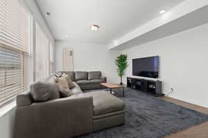 Large open concept living room featuring ample windows, 9' ceilings, and LVP flooring