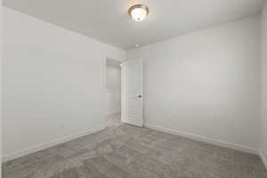 Second floor spare bedroom with large window and walk-in closet