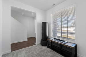 Main floor office space with carpet flooring and large window