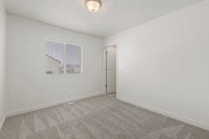 Second floor spare bedroom with large window and walk-in closet