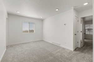 Second floor loft/living room space featuring carpet flooring and a south facing window